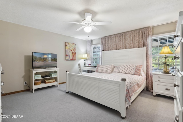 bedroom with ceiling fan and light colored carpet