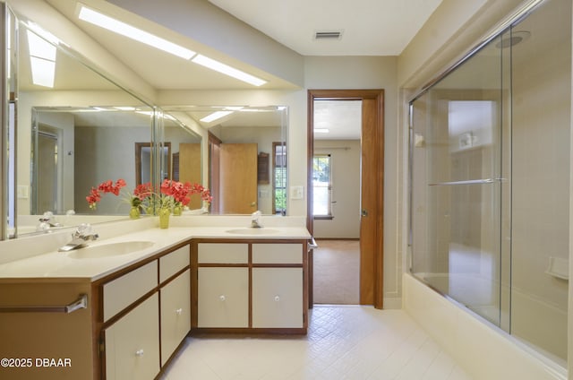 bathroom featuring vanity and enclosed tub / shower combo