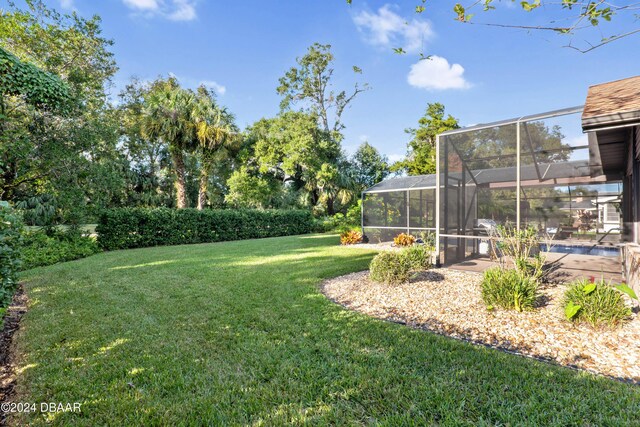 view of pool featuring glass enclosure, area for grilling, and a patio area