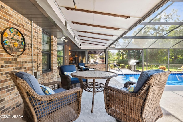 view of patio / terrace featuring glass enclosure