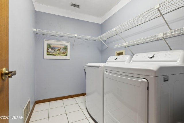 washroom with independent washer and dryer and light tile patterned floors