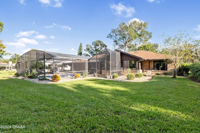 rear view of property with a yard