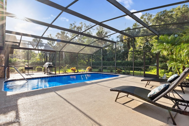 view of pool with a patio and a lanai