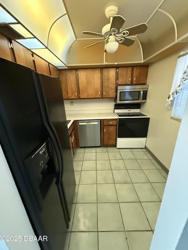 kitchen with light tile patterned floors, ceiling fan, and appliances with stainless steel finishes