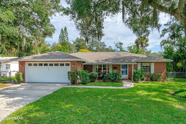 single story home featuring a garage and a front lawn