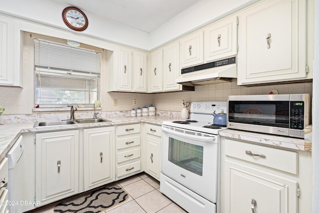 kitchen with white cabinetry, tasteful backsplash, sink, and white appliances