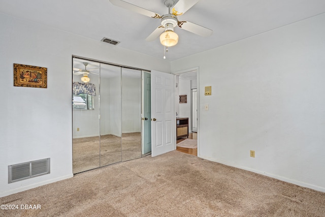 unfurnished bedroom featuring carpet floors, ceiling fan, and a closet