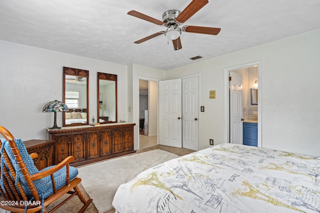 carpeted bedroom featuring a closet, a textured ceiling, ceiling fan, and ensuite bathroom