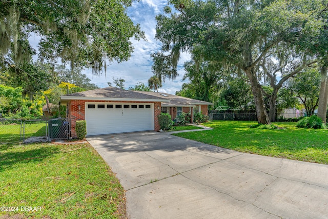 ranch-style house featuring a garage and a front yard