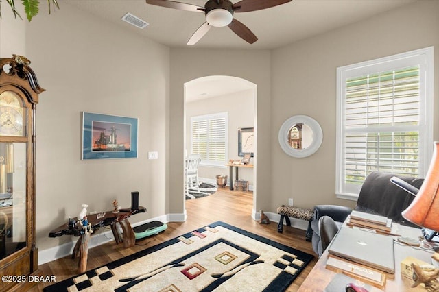 6341 Hanfield Dr, Port Orange, FL 32128 - living area with visible vents, baseboards, arched walkways, ceiling fan, and wood finished floors
