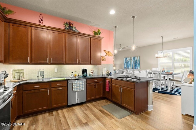 6341 Hanfield Dr, Port Orange, FL 32128 - kitchen with tasteful backsplash, light wood-style floors, a sink, and appliances with stainless steel finishes