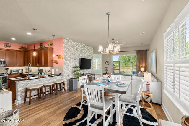 6341 Hanfield Dr, Port Orange, FL 32128 - dining room featuring a chandelier, light wood finished floors, and recessed lighting