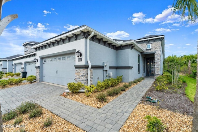 6341 Hanfield Dr, Port Orange, FL 32128 - view of front facade with decorative driveway, stone siding, a garage, and stucco siding