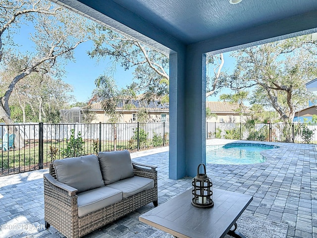 view of patio featuring a fenced in pool and an outdoor living space