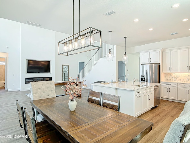 dining room featuring sink and light hardwood / wood-style flooring