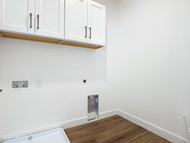 washroom with hookup for an electric dryer, hookup for a washing machine, cabinets, and hardwood / wood-style flooring