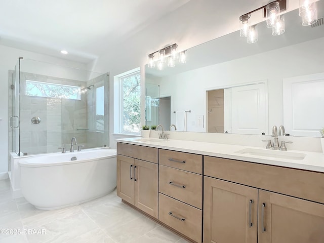 bathroom with vanity and shower with separate bathtub