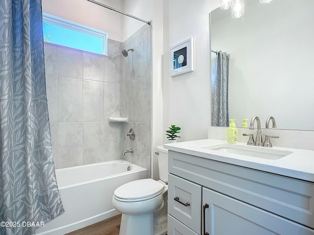 full bathroom with wood-type flooring, vanity, shower / tub combo, and toilet