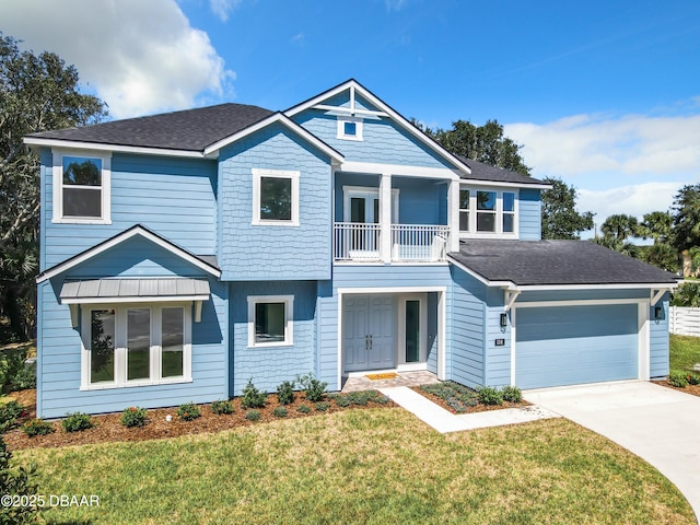 view of front of property featuring a garage, a front yard, and a balcony