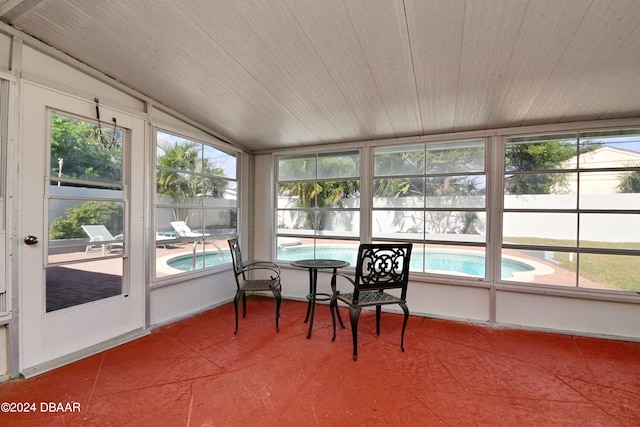 sunroom / solarium featuring wooden ceiling, a wealth of natural light, and vaulted ceiling