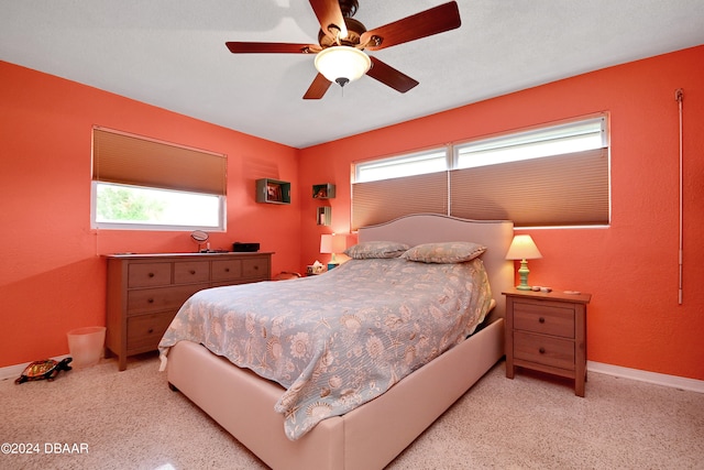 bedroom featuring multiple windows and ceiling fan