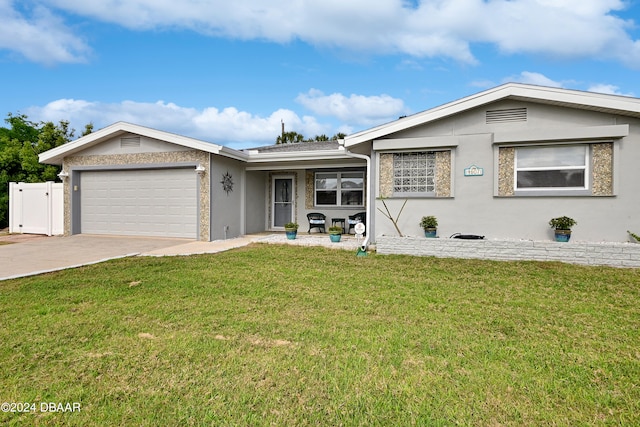 single story home featuring a garage and a front lawn