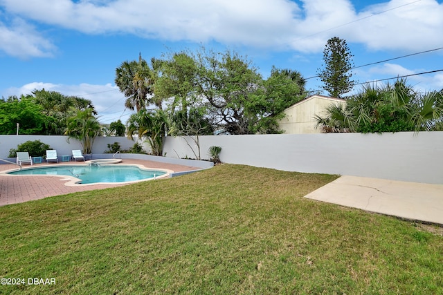 view of swimming pool featuring a patio and a lawn