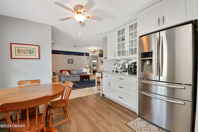 kitchen featuring white cabinetry, stainless steel fridge with ice dispenser, ceiling fan, and light wood-type flooring