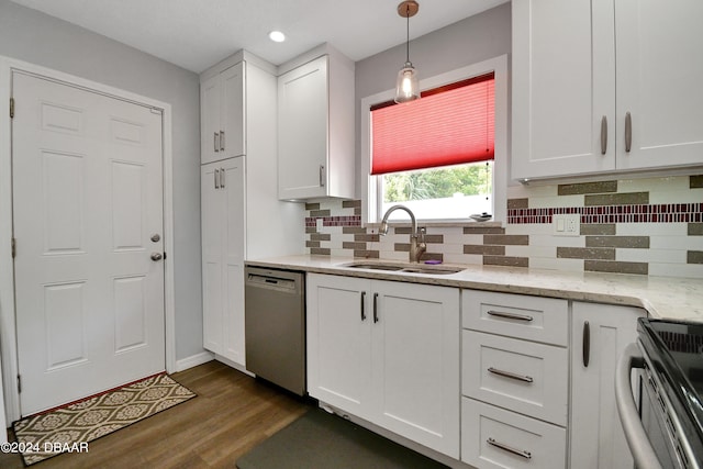 kitchen featuring white cabinets, appliances with stainless steel finishes, hanging light fixtures, and sink