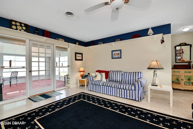 living room featuring ceiling fan and a healthy amount of sunlight