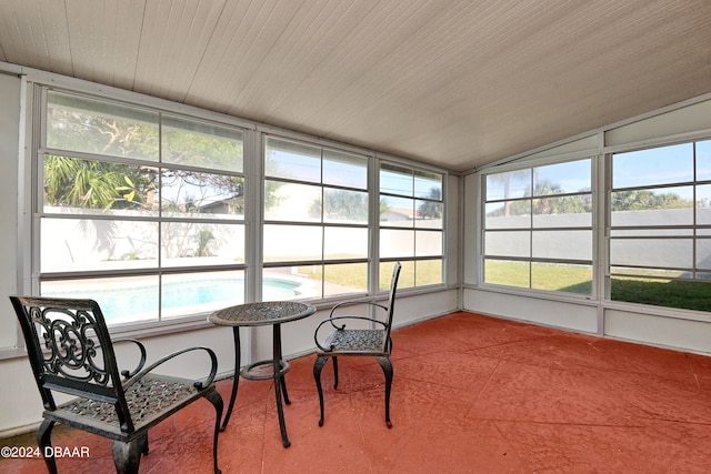 sunroom / solarium featuring plenty of natural light and vaulted ceiling