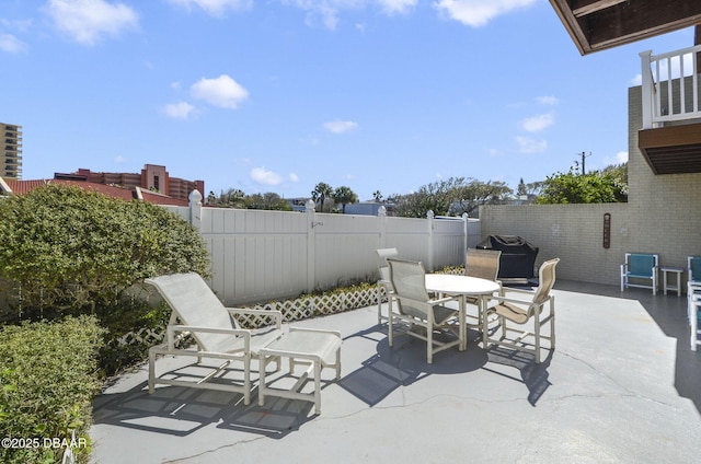 view of patio / terrace featuring a fenced backyard, outdoor dining area, and grilling area