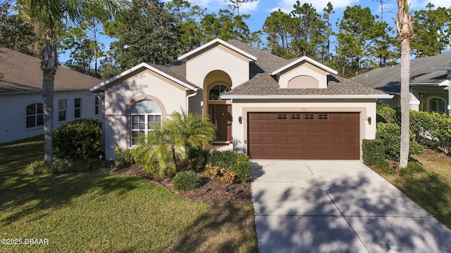 view of front of home featuring a garage and a front yard