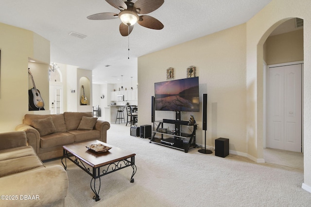 carpeted living room featuring ceiling fan