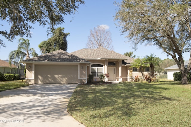 single story home with an attached garage, a front yard, concrete driveway, and stucco siding