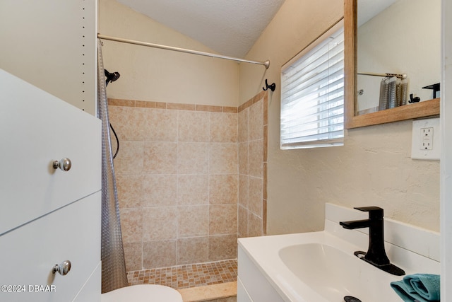 bathroom with sink, a shower with curtain, a textured ceiling, and toilet