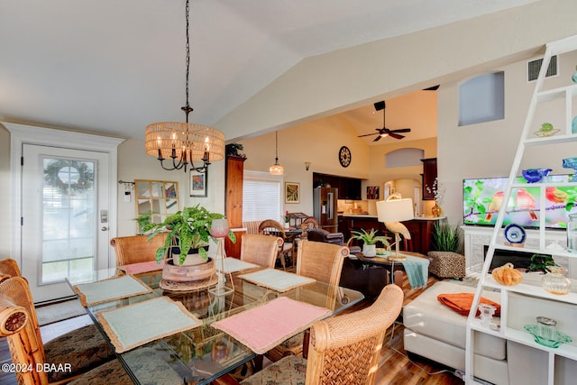 dining space featuring wood-type flooring, lofted ceiling, a healthy amount of sunlight, and ceiling fan with notable chandelier