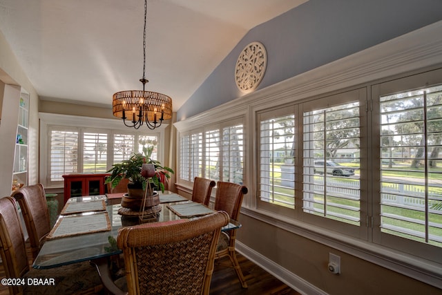 dining space featuring an inviting chandelier, vaulted ceiling, dark hardwood / wood-style floors, and a healthy amount of sunlight