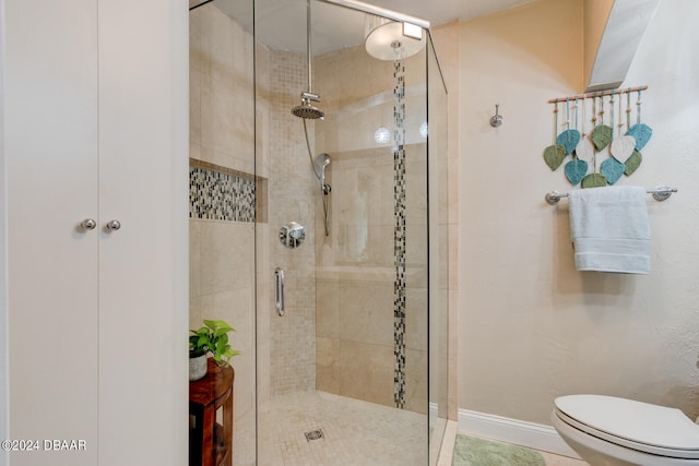 bathroom with a shower with shower door, tile patterned floors, and toilet