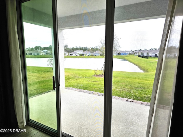 entryway featuring a water view, a residential view, and wood finished floors