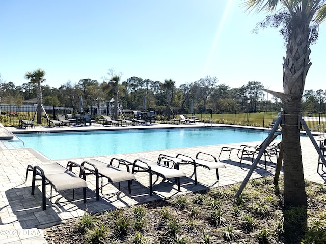 pool featuring fence and a patio