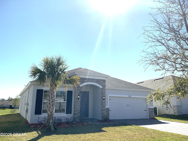 view of front of home with an attached garage, a shingled roof, driveway, stucco siding, and a front lawn