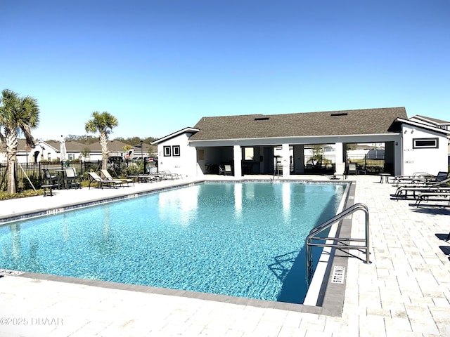 community pool featuring a patio area and fence