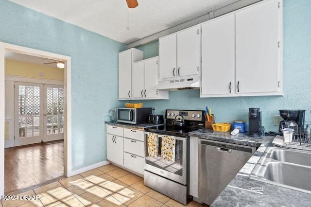 kitchen with white cabinets, ceiling fan, light hardwood / wood-style flooring, and appliances with stainless steel finishes