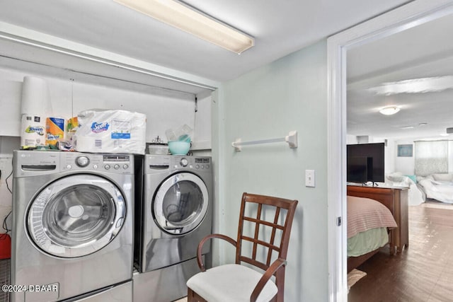 washroom with dark hardwood / wood-style floors and washer and dryer