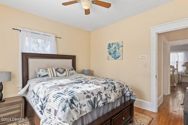 bedroom with ceiling fan and light wood-type flooring