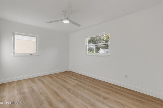 empty room with light hardwood / wood-style floors and ceiling fan