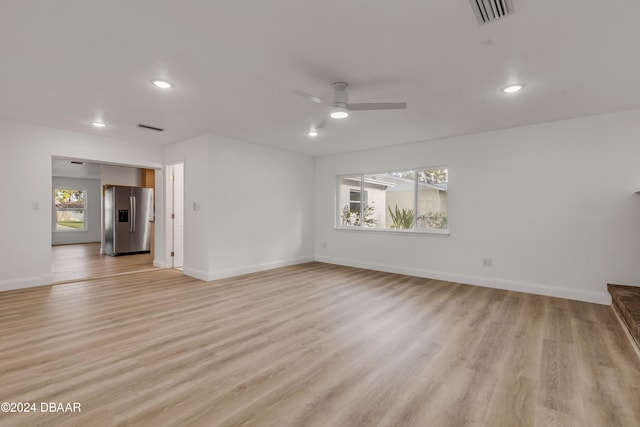 unfurnished living room featuring light hardwood / wood-style floors and ceiling fan