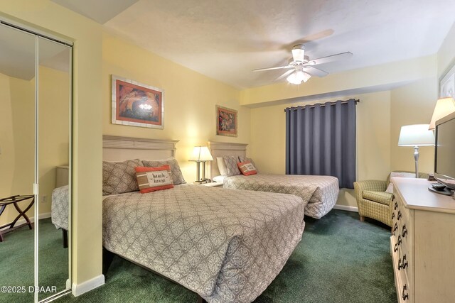 bedroom featuring a closet, dark carpet, a ceiling fan, and baseboards