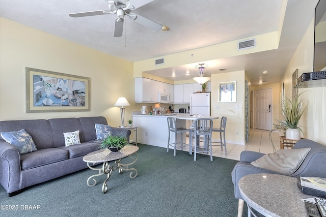 living area with light tile patterned floors, visible vents, light carpet, and a ceiling fan